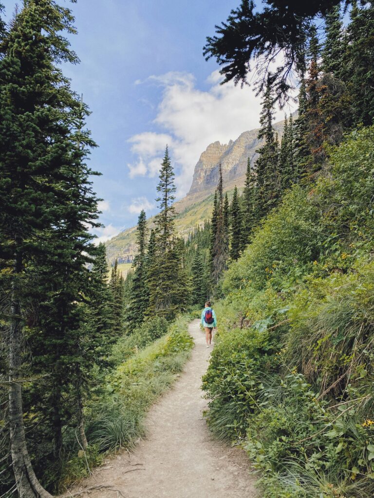Girl walking along trail in Glacier National Park
